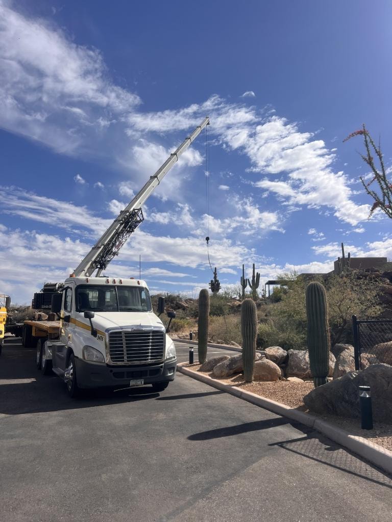 Crane truck working in a landscaped desert setting