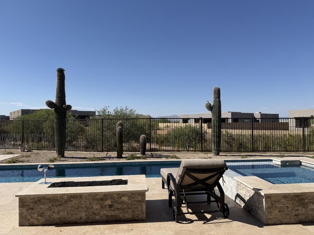 Poolside desert landscape with mature saguaros and mountain views